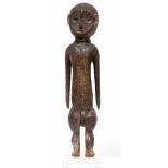 DRC., Ngbaka, standing male figure,with elongated torso and arms, bulbous legs and concave carved