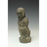 Indonesia, carved vulcano stone figure,squating figure with hands on knees. Provenance, Indonesian