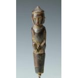 Borneo, Dayak, awl, the iron pin surmounted by a wooden, squatting man with prominent sex; l. 13,5