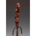 Lombok, bettelnut iron pounder, 19th century,the handle carved as a squatting figure dressed in loin