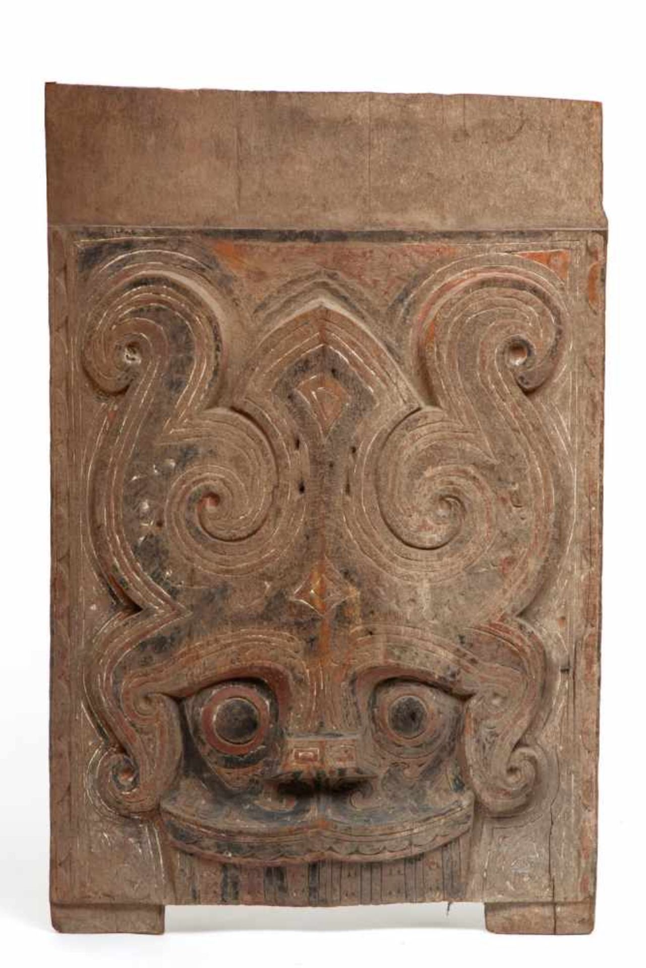 Sumatra, Toba Batak, wooden rectangular architectural pannel decorated with a Singa headtraces of