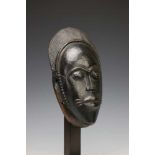 Ivory Coast, Baule, face mask,with articulated lips, slanting eyes and rows of keloid