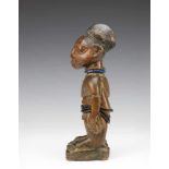 Yoruba, Igbominia, standing male Ibeji figure,with two triangular shaped necklaces, wearing flip