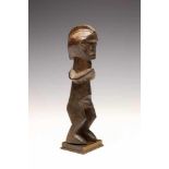 DRC., Mbala-Hungaan, standing male figureWith hairstyle in ridge and curved arms joining at the