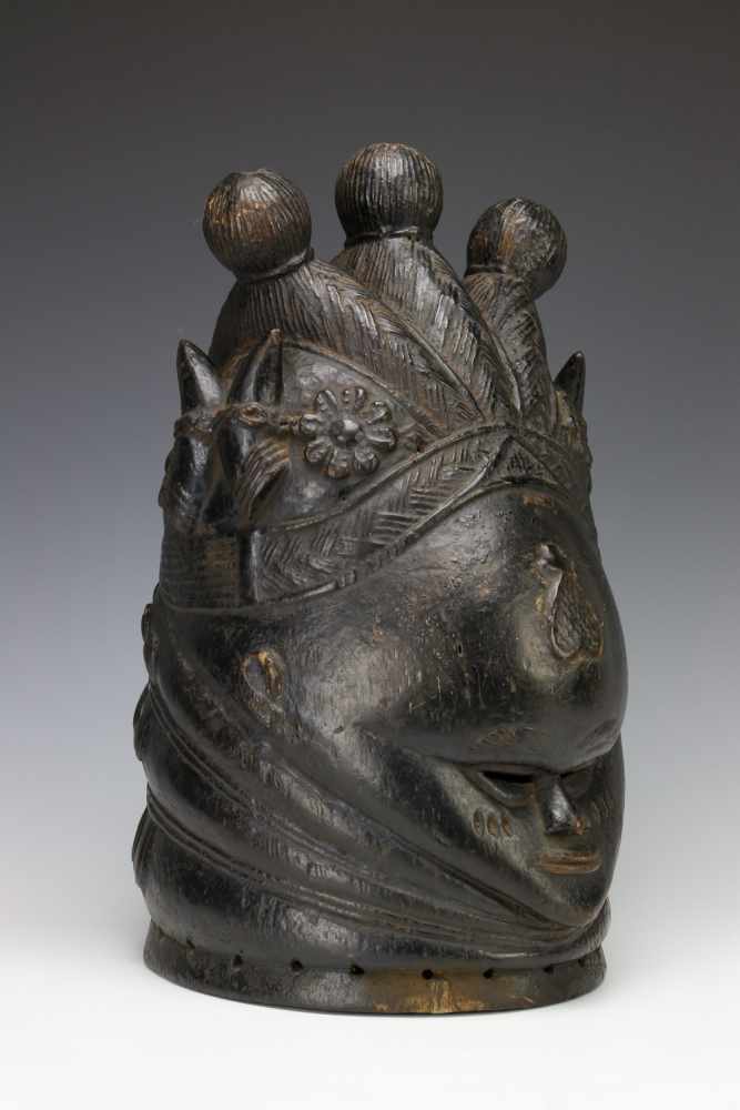 Sierra Leone, Mende, helmetmask, sowei,with three braids ending in and on the side carved flower