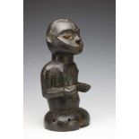 Eket, crest mask,in the form of a half figure with arms in front on body and black patina.; h. 30