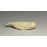 Arctic Circle, ivory toggle shapes as a whale, early 20th century.Herewith an ivory button shapes as