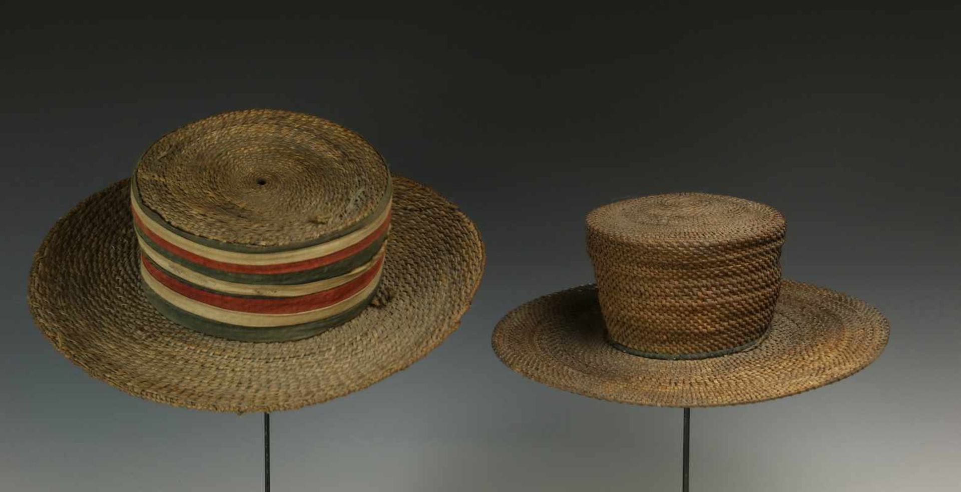 DRC., two braided plantfiber hatsone with colored cotton bands and both with a wooden support