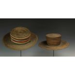 DRC., two braided plantfiber hatsone with colored cotton bands and both with a wooden support