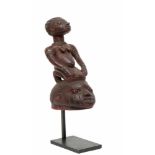 Nigeria, Yoruba, gelede masksurmounted by a seated female figure with scarification and wearing