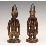 Yoruba, Igbomina, two female Ibeji figuresboth with a carved cord on hips and with necklaces. With