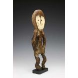 DRC., Mbole, anthropomorphic figure, okifa,with oval head, hart shaped face, bent arms and legs,