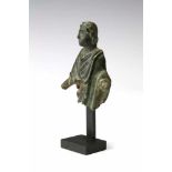 Roman bronze fragment of a man in toga, ca. 1st century.wearing a laurel wreath and with remnants of
