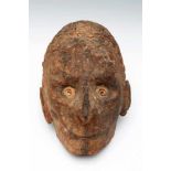 PNG, Sepik, overmoddelled human skull,with spiral shell inlaid eyes, inlaid cowry shells and grey-