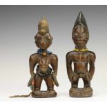 Yoruba, Oyo, male and female Ibeji figurefemale figure with many old bracelets. Provenance Old Dutch
