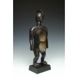 Nigeria, Koro, wooden ceremonial dish in the form of a standing figure, gbene,with broad flattened