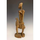 Mali, weathered wooden sculpture of an equestrian,the rider holding a child figure in the right hand