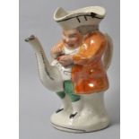 Figurenteekanne/ Toby tea pot, 2. H. 19. Jh.Steingut, polychrome Bemalung, teils Lüsterbemalung.