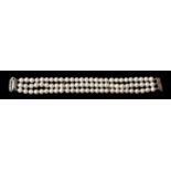 Perlarmband, 20. Jh.Drei Stränge cremefarbener Perlen, D. je ca. 6 mm. Dekorativ gearbeitete