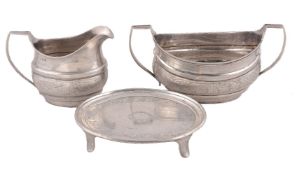 A George III Irish silver tea pot stand, sugar basin and milk jug by Robert Breading, Dublin 1805