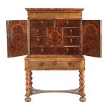 An oyster walnut veneered chest on stand