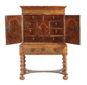 An oyster walnut veneered chest on stand