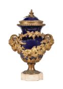 A gilt metal and marble mounted blue glazed ceramic urn and cover in Louis XVI style, circa 1900