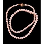 ϒ A graduated pale coral bead necklace