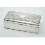 A silver rectangular cigarette box by Charles S Green & Co Ltd