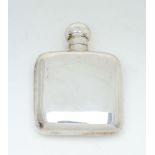 A silver rounded rectangular small spirit flask by Cohen & Charles