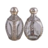 A pair of Mexican silver coloured and glass decanters
