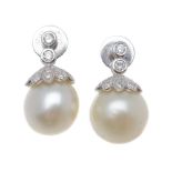 A pair of cultured pearl and diamond earrings