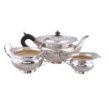 A matched silver compressed spherical three piece tea service