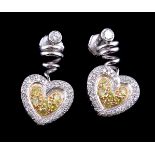 A pair of diamond and yellow diamond earrings
