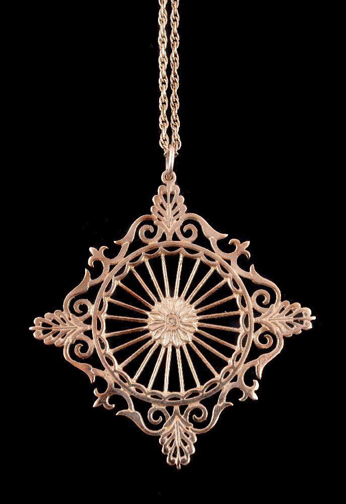 A pierced gold pendant on chain