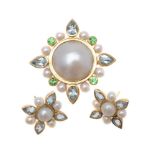 An 18 carat gold mabé pearl, aquamarine and tsavorite garnet brooch by Pippa Ramsay Rae