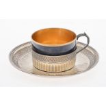 A French silver and porcelain cup and saucer by Henin & Cie.