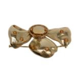 A citrine bow brooch