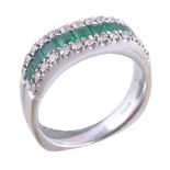 An 18 carat gold emerald and diamond ring
