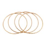 Four gold coloured bangles