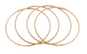 Four gold coloured bangles