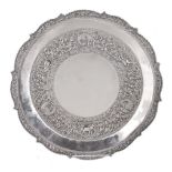 An Indian silver coloured shaped circular tray or salver