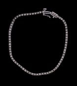 An 18 carat gold diamond tennis bracelet