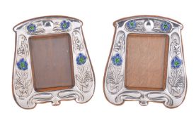 A pair of matched Arts and Crafts silver photograph frames