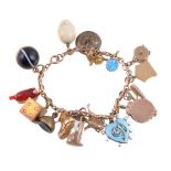 ϒ A gold coloured charm bracelet and charms