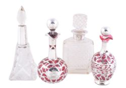 Four silver mounted glass scent or cologne bottles