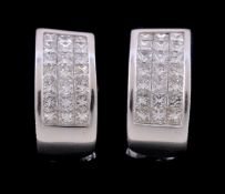 A pair of diamond earrings, the curved panels set with princess cut diamonds, approximately 2.58