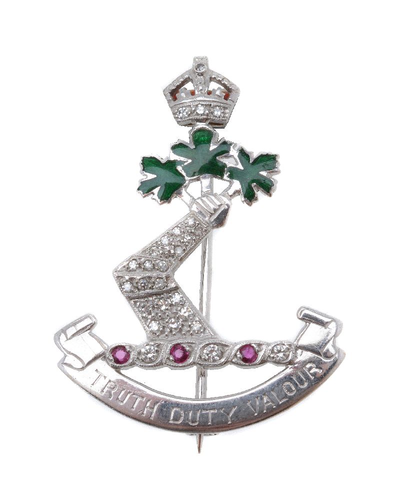 A diamond and ruby Royal Military College of Canada sweetheart brooch, the pavé set diamond gauntlet