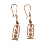 A pair of Egyptian gold coloured earrings, the cartouche shaped panels with a pierced design,