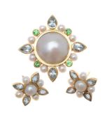 An 18 carat gold mabé pearl, aquamarine and tsavorite garnet brooch by Pippa Ramsay Rae